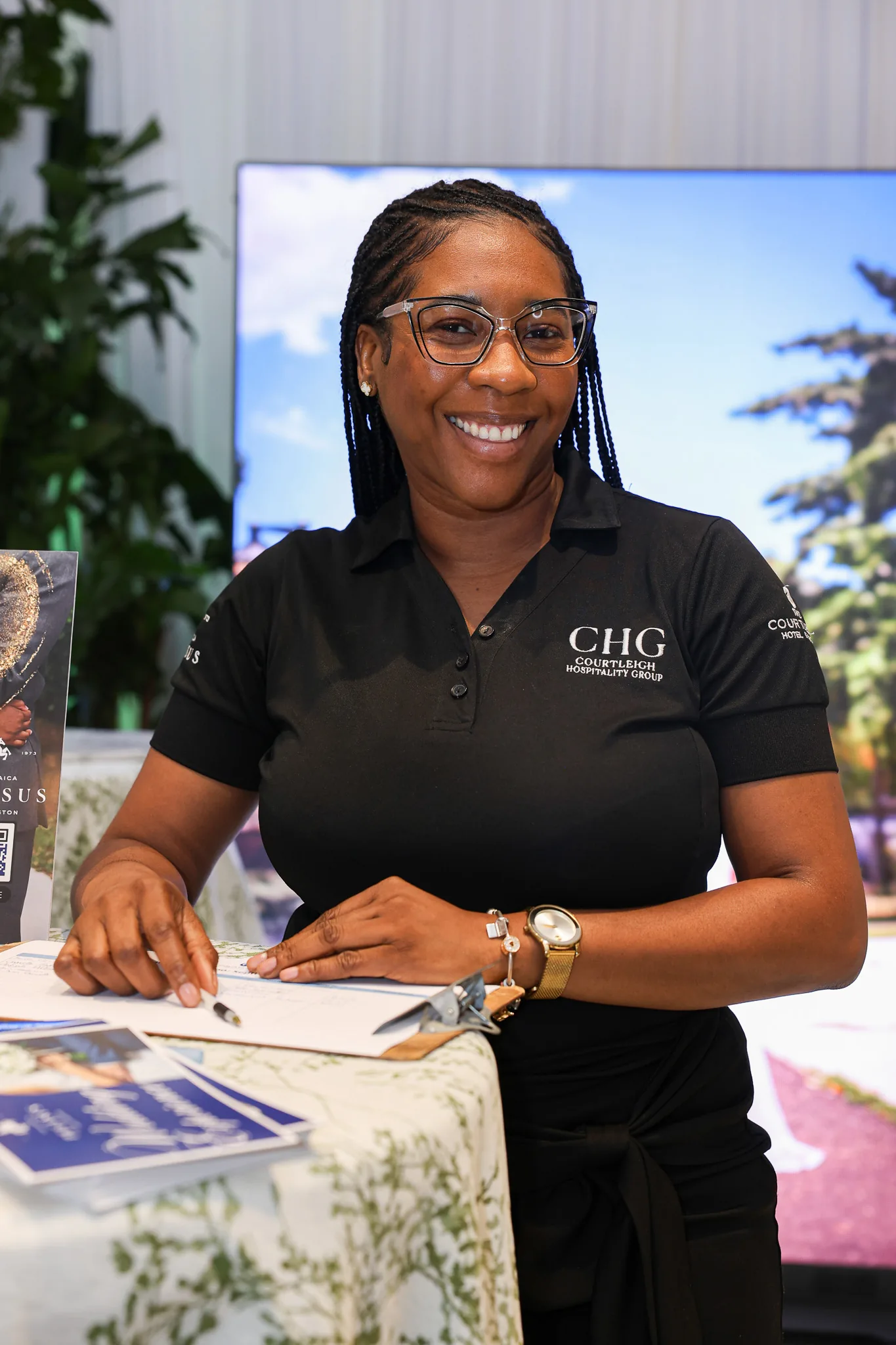 A smiling exhibitor welcomes visitors at her booth