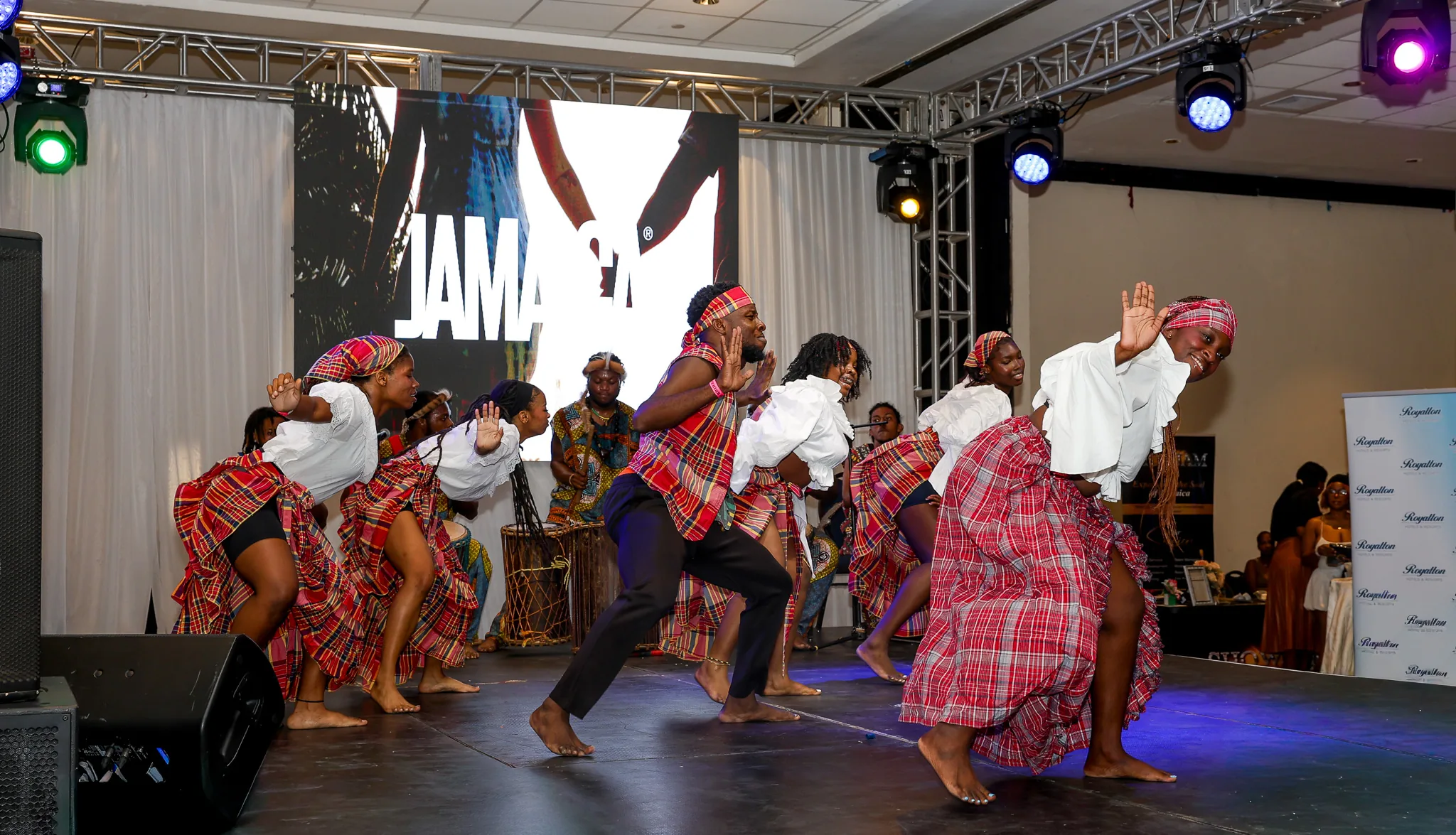 Dancers in traditional costumes perform on the expo stage