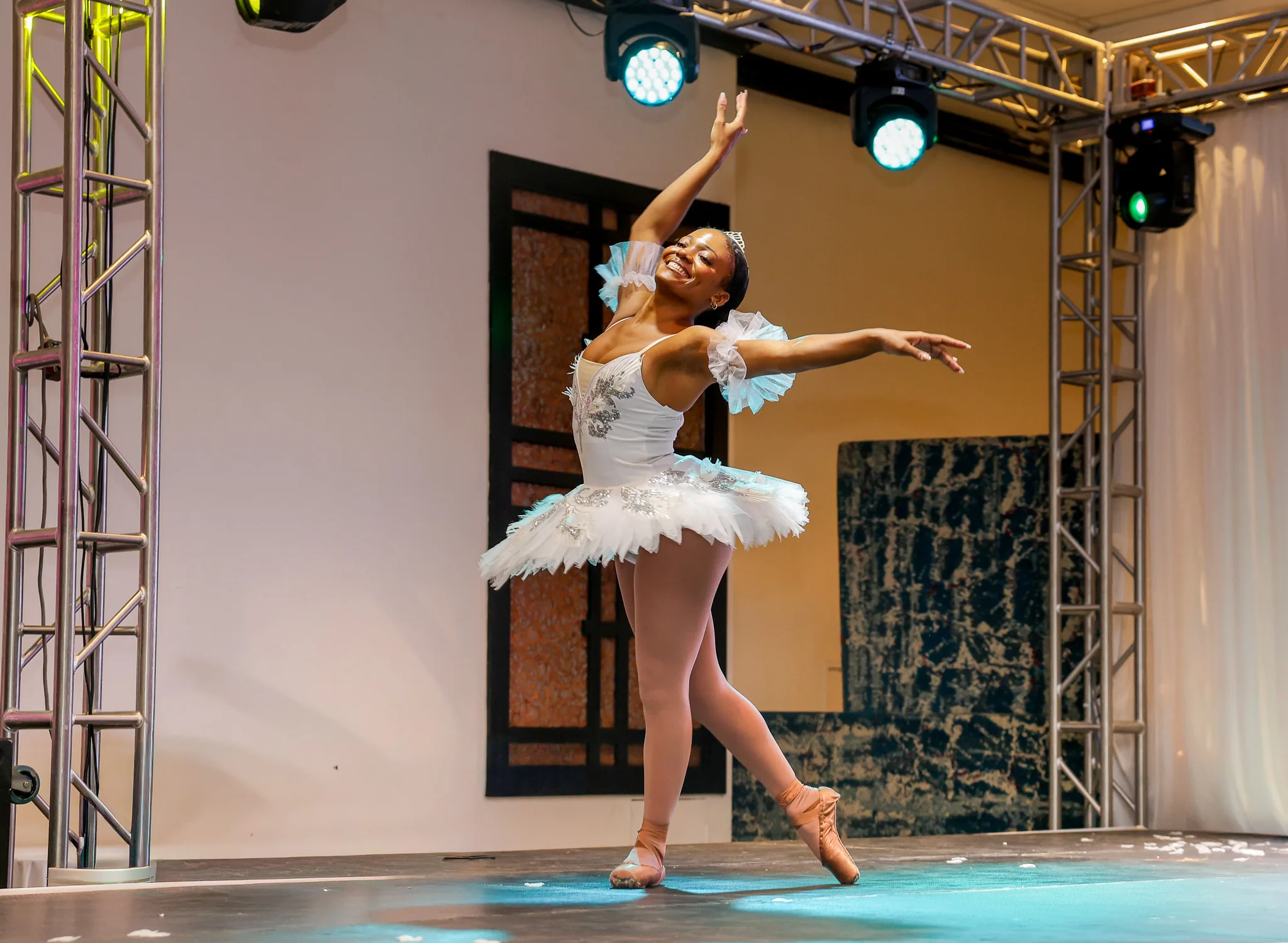 A ballerina strikes a graceful pose on the runway