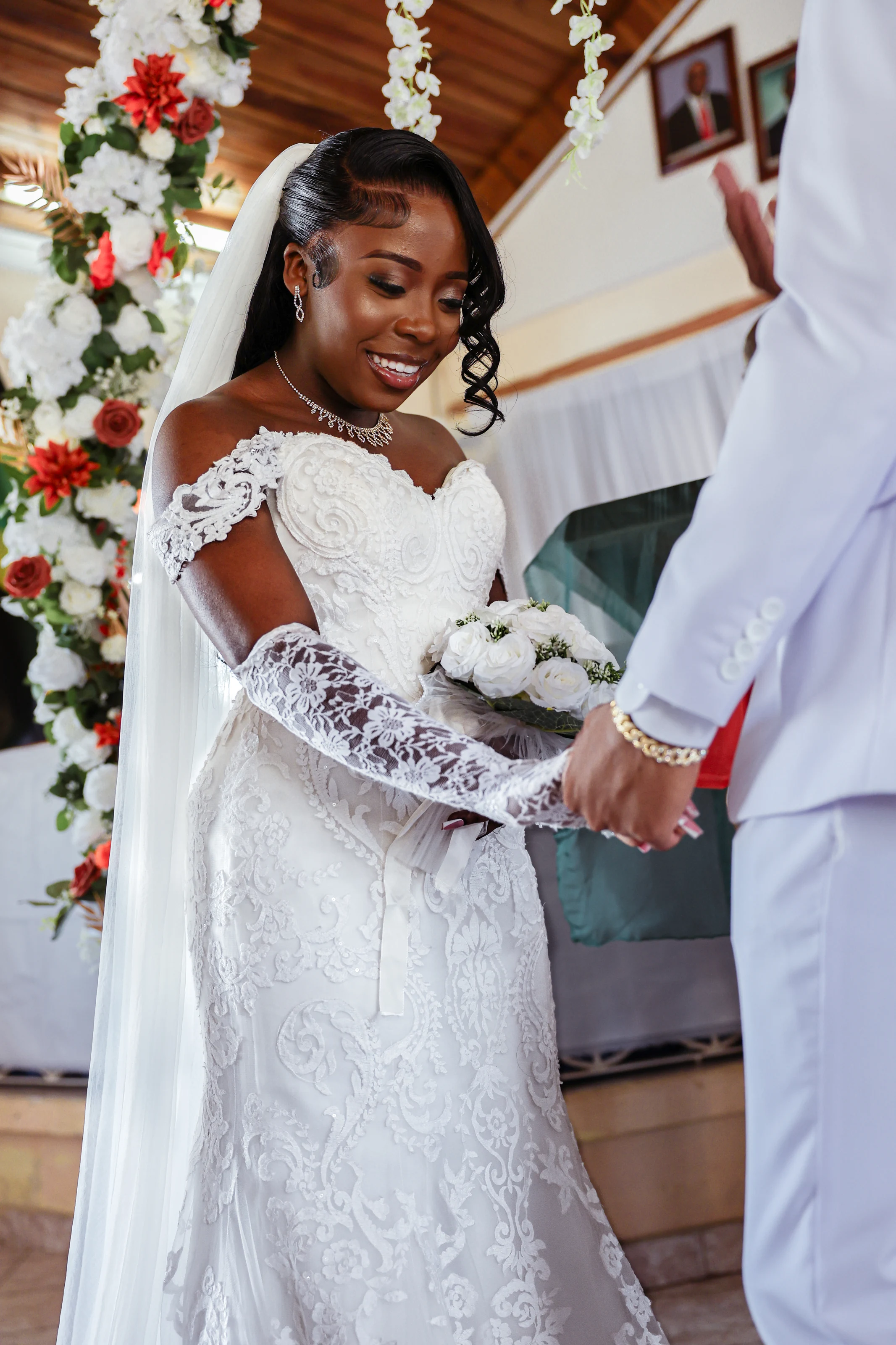 Bride holding a bouquet and her groom's hand during the ceremony